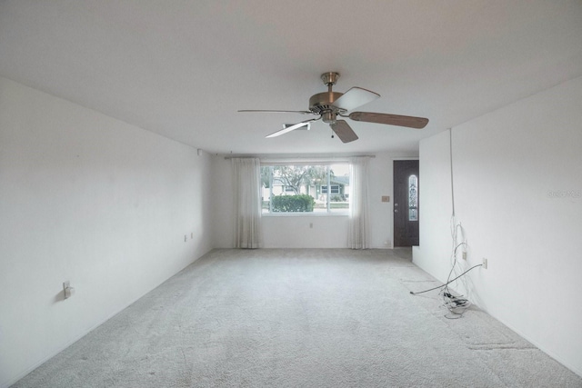 empty room featuring carpet flooring and ceiling fan