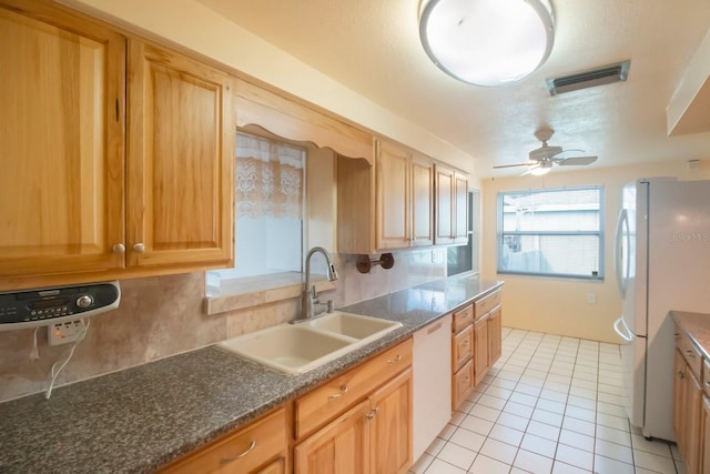 kitchen featuring ceiling fan, sink, tasteful backsplash, white appliances, and light tile patterned flooring