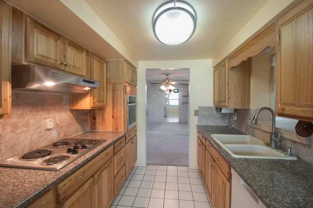 kitchen featuring ceiling fan, sink, stainless steel appliances, tasteful backsplash, and light tile patterned flooring