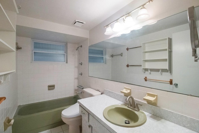 full bathroom featuring vanity, decorative backsplash, tiled shower / bath combo, toilet, and tile walls