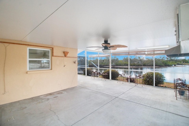 view of patio / terrace featuring a water view, glass enclosure, and ceiling fan