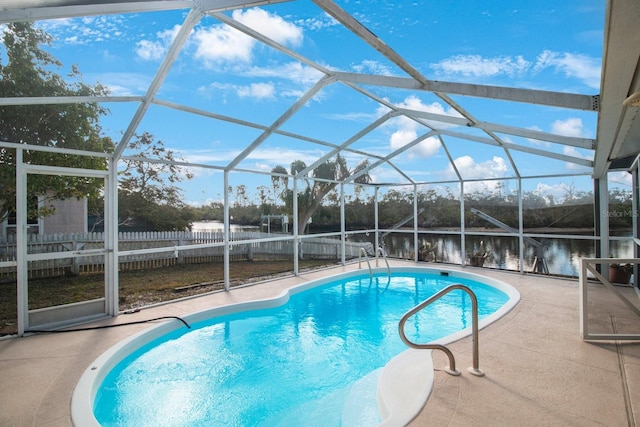 view of swimming pool featuring a water view, a patio area, and a lanai