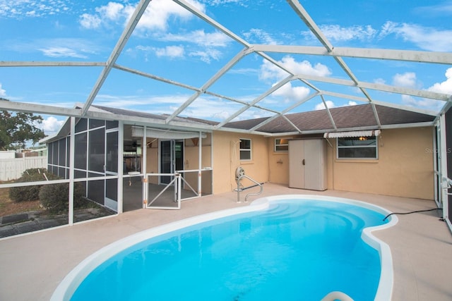 view of swimming pool featuring glass enclosure and a patio area