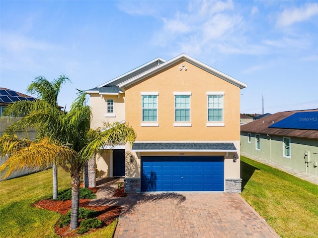 view of front of home with a front yard and a garage