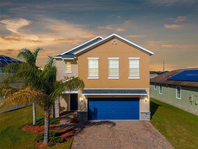 view of front of home featuring a lawn and a garage