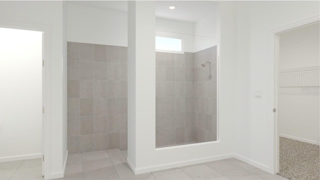 bathroom featuring a tile shower and tile patterned floors