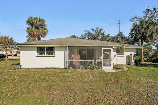 back of house featuring a sunroom and a yard