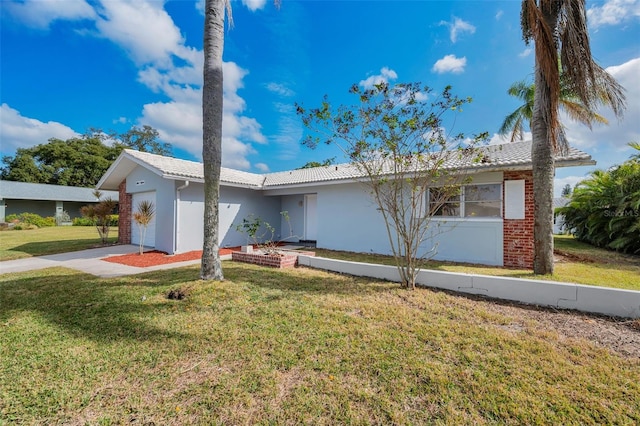 ranch-style home with a front lawn and a garage