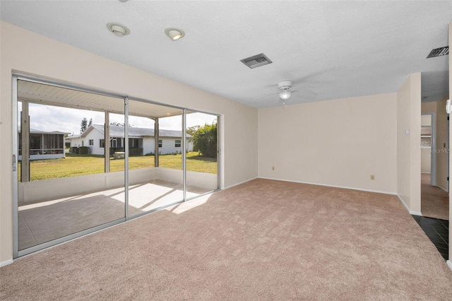 carpeted spare room featuring ceiling fan