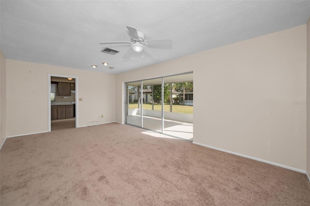 spare room with ceiling fan and carpet floors