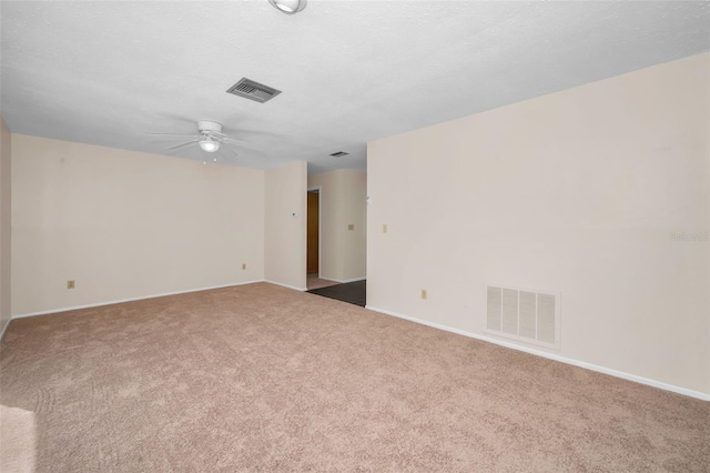 carpeted empty room featuring a textured ceiling and ceiling fan