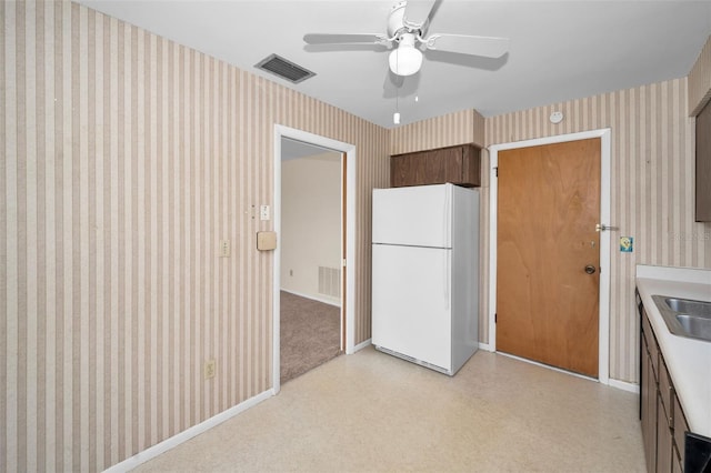 kitchen with white refrigerator, ceiling fan, and sink