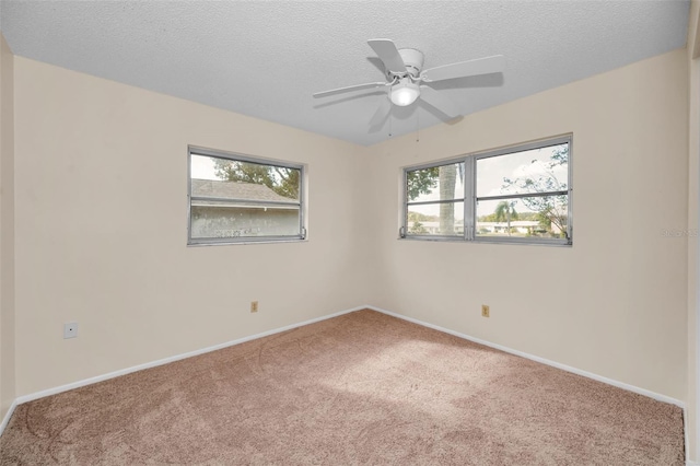 carpeted spare room with ceiling fan and a textured ceiling