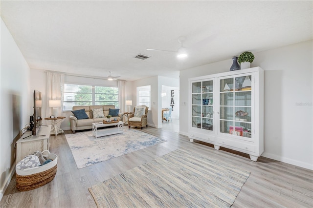 living room featuring ceiling fan and light wood-type flooring