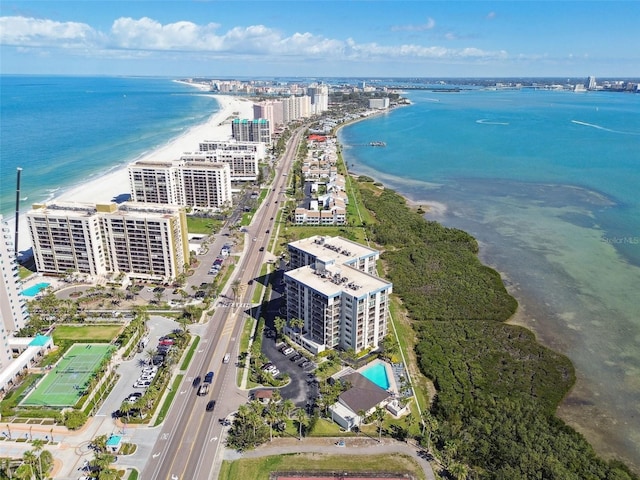 birds eye view of property featuring a water view, a beach view, and a city view