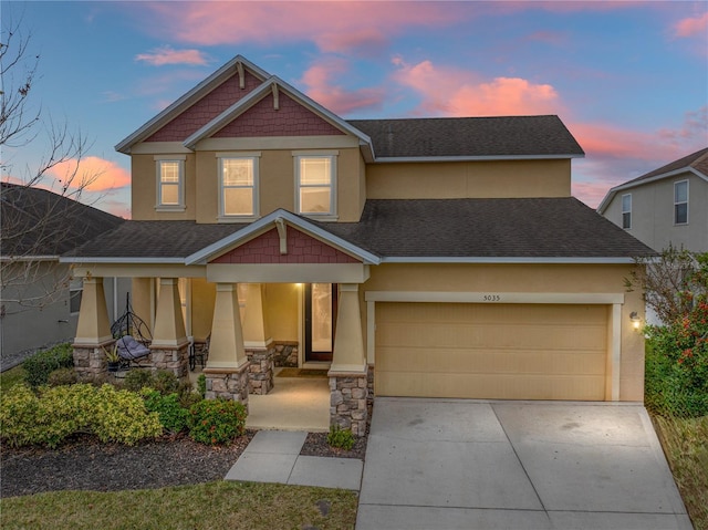 craftsman-style home featuring a porch and a garage