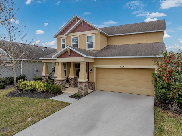 view of front of home with covered porch, a garage, and a front lawn