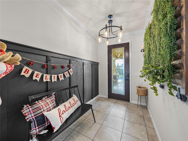 tiled entryway with crown molding and an inviting chandelier