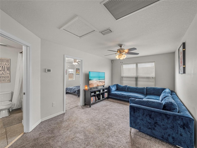 living room featuring carpet, a textured ceiling, and ceiling fan