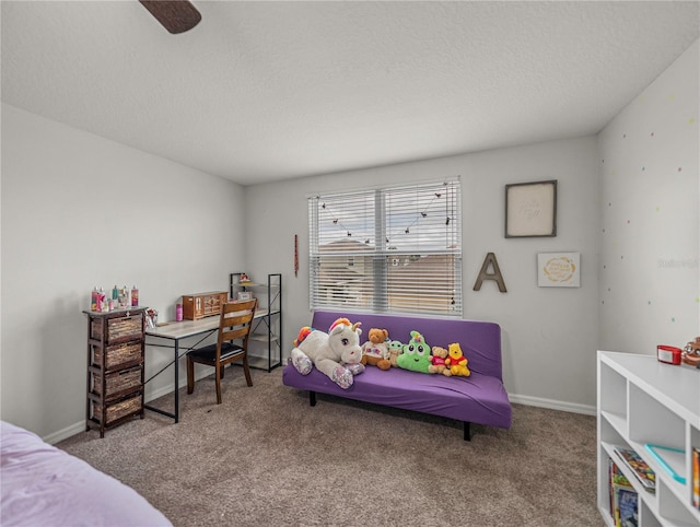 carpeted bedroom with ceiling fan and a textured ceiling