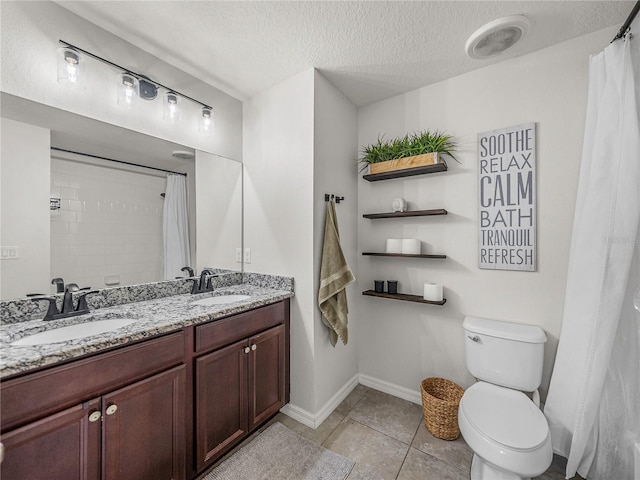 bathroom featuring vanity, tile patterned flooring, a shower with shower curtain, toilet, and a textured ceiling