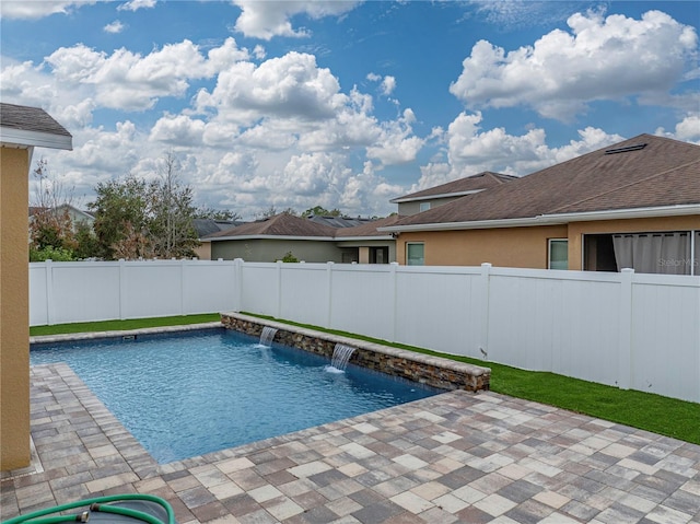 view of pool with pool water feature and a patio