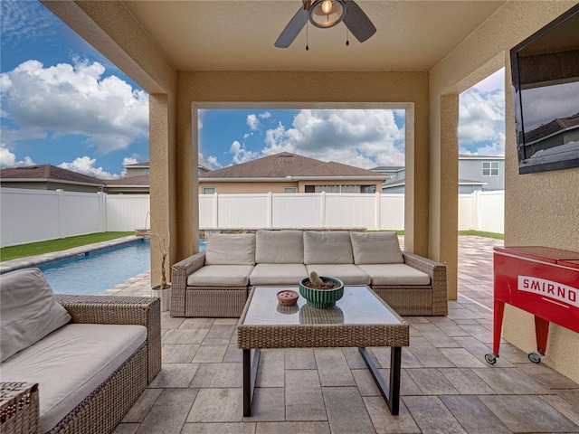 view of patio featuring outdoor lounge area, ceiling fan, and a fenced in pool