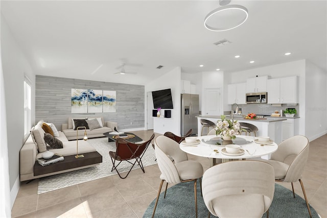 dining area with light tile patterned floors and ceiling fan