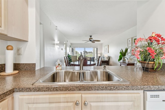 kitchen with ceiling fan, dishwashing machine, sink, and light brown cabinets