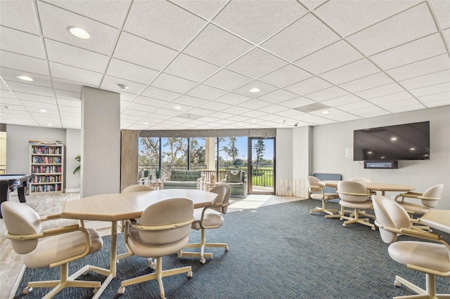 dining space featuring expansive windows and carpet flooring