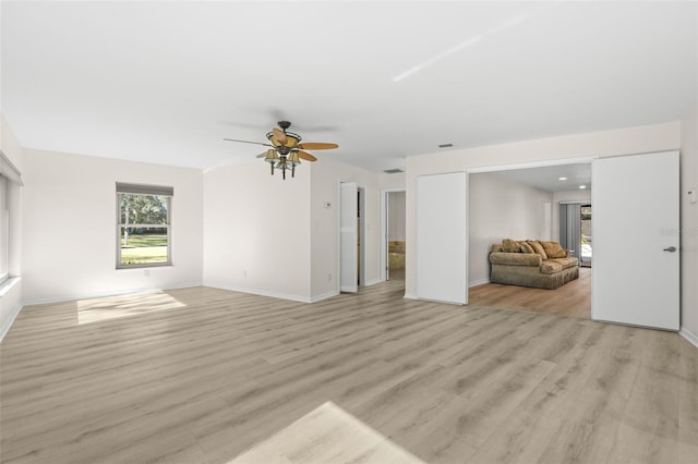 unfurnished living room featuring ceiling fan and light wood-type flooring