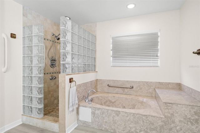 bathroom with wood-type flooring and independent shower and bath