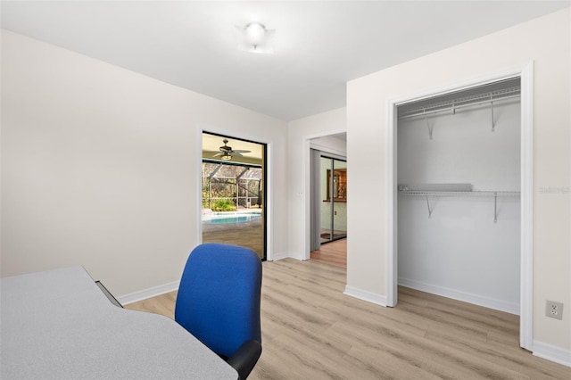 office space with ceiling fan and light hardwood / wood-style floors