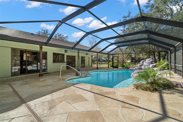 view of swimming pool with a lanai, a patio area, and ceiling fan