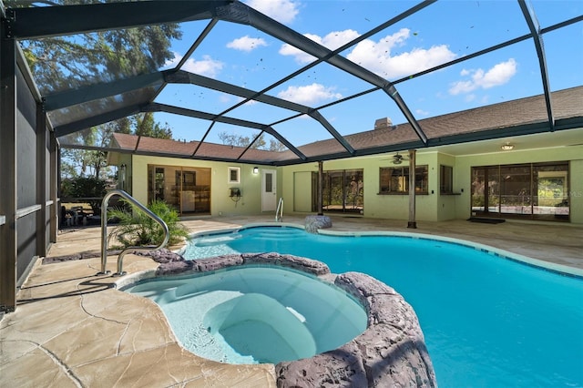 view of pool featuring a lanai, an in ground hot tub, ceiling fan, and a patio