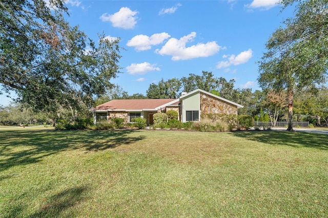 ranch-style house with a front lawn