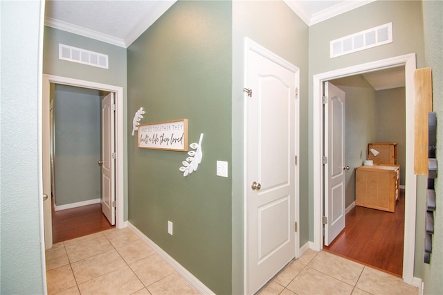 hall with crown molding and light hardwood / wood-style flooring