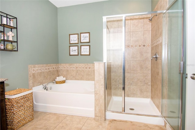 bathroom with tile patterned flooring and separate shower and tub