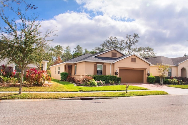 ranch-style home with a garage and a front yard