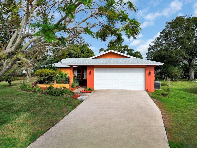 single story home with a garage, central air condition unit, and a front yard