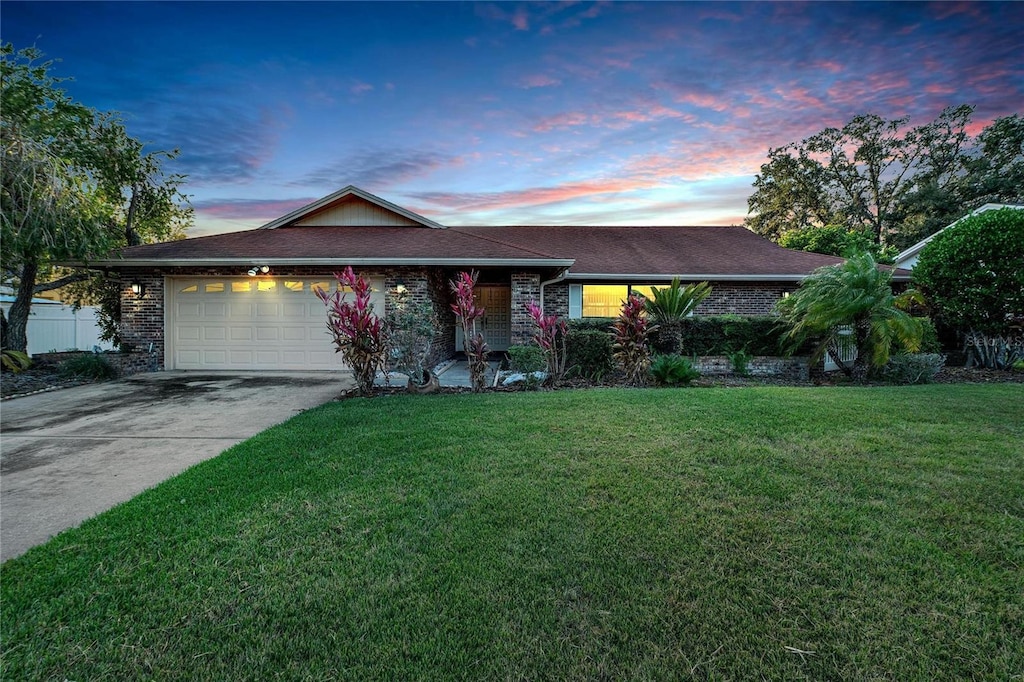 ranch-style home with a lawn and a garage