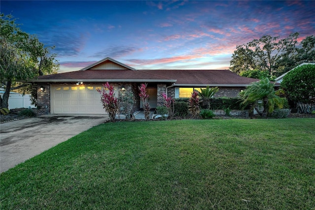 ranch-style home with a lawn and a garage