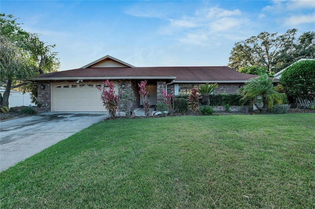 single story home with a garage and a front lawn