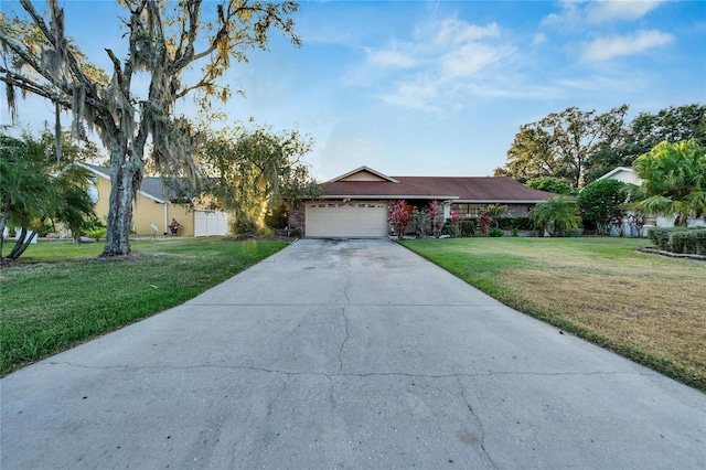 ranch-style home featuring a garage and a front lawn