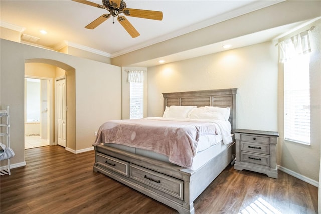 bedroom with ceiling fan, dark hardwood / wood-style flooring, crown molding, and ensuite bath