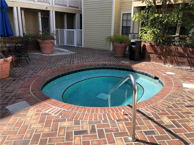 view of pool with an in ground hot tub