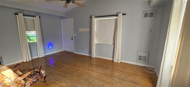 entrance foyer with hardwood / wood-style flooring, vaulted ceiling, and ceiling fan