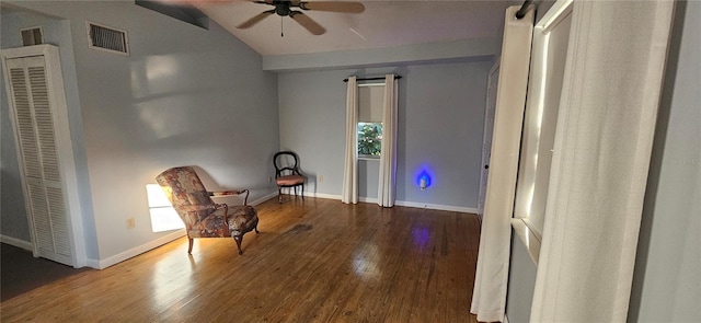 living area with lofted ceiling, ceiling fan, and dark wood-type flooring