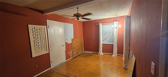 hallway featuring beamed ceiling, light hardwood / wood-style floors, a textured ceiling, and an inviting chandelier