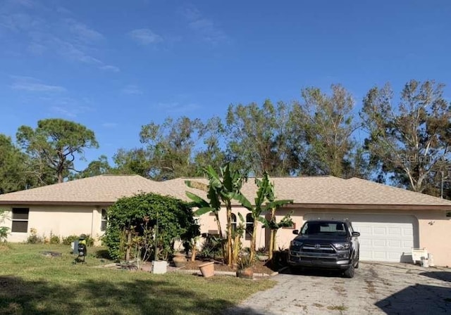 ranch-style house with a garage and a front lawn